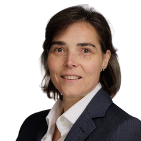 A woman with short brown hair in a dark suit jacket and white collared shirt smiles at the camera against a plain white background. EFESO Management Consultants